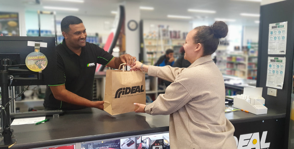 Ideal Electrical staff serving a customer in a branch with electrical tools and supplies